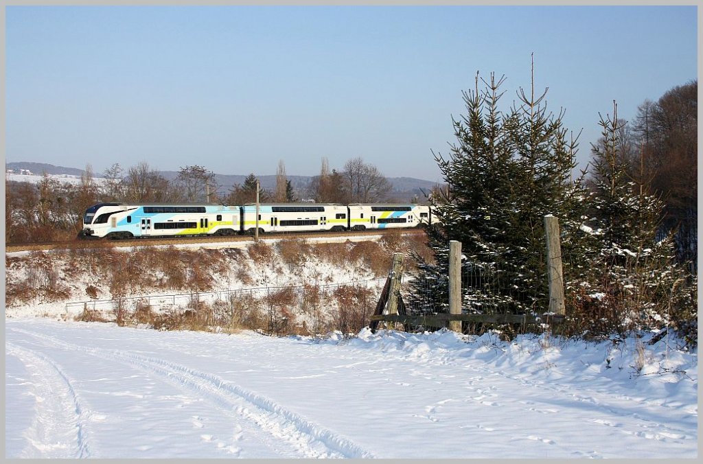 WESTbahn 17516 Richtung Freilassing am 12. Februar 2012 kurz nach der Durchfahrt in Unter Oberndorf. 