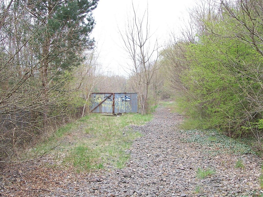 Wohl kurz nach der Wende stillgelegt, liegen hier schon einige Jahre keine Gleise mehr.
Geradeaus erreicht man nach 500m das Messingwerk-Neuwerk (nach 1945 Walzwerk Finow), auf der linken Seite das Einfahrtstor zum Messingwerk-Altwerk (zu DDR-Zeiten NVA-Teilelager) 19.04.2008