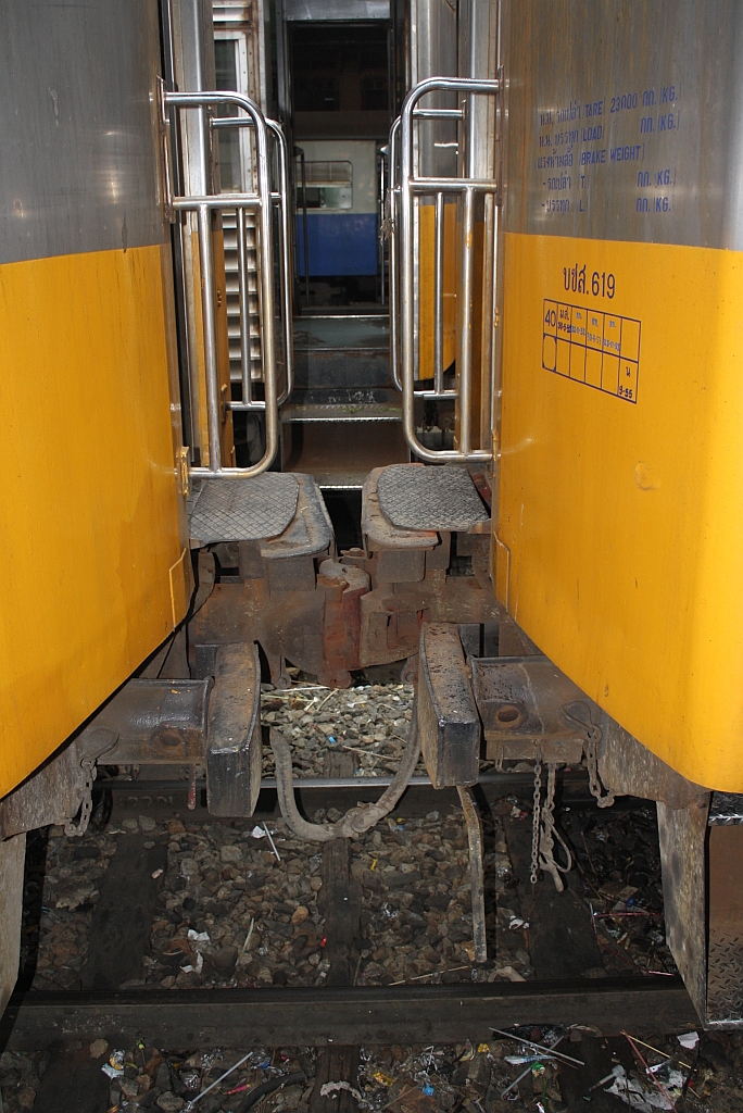 Würde bei uns keine Zulassung bekommen, regt aber in Thailand niemand auf. Übergang vom บชส. 613 auf den บชส. 619 (บชส = BTC/Bogie Third Class Carriage) am 16.März 2011 im Bf. Hua Lamphong. Die Wagen บชส. 601-621 wurden 1995 von der australischen Queensland Railway erworben.
