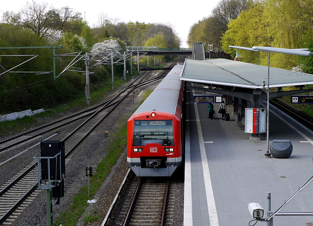 Zug der Hamburger S-Bahnlinie S1 Richtung Wedel in der Station  Rbenkamp . Links im Bild zweigt die sogenannte Gterumgehungsbahn Richtung Eidelstedt ab. 5.5.2013