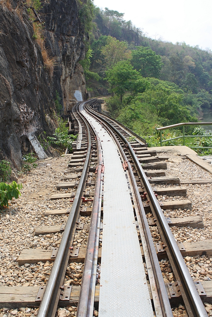 Zwischen den Bf. Saphan Tham Krasae und Tham Krasae ist die Strecke wegen der Enge zwischen dem Kwai Noi und dem Bergmassiv als Viadukt ausgeführt. Blick von Tham Krasae in Richtung Saphan Tham Krasae am 12.März 2012. 


