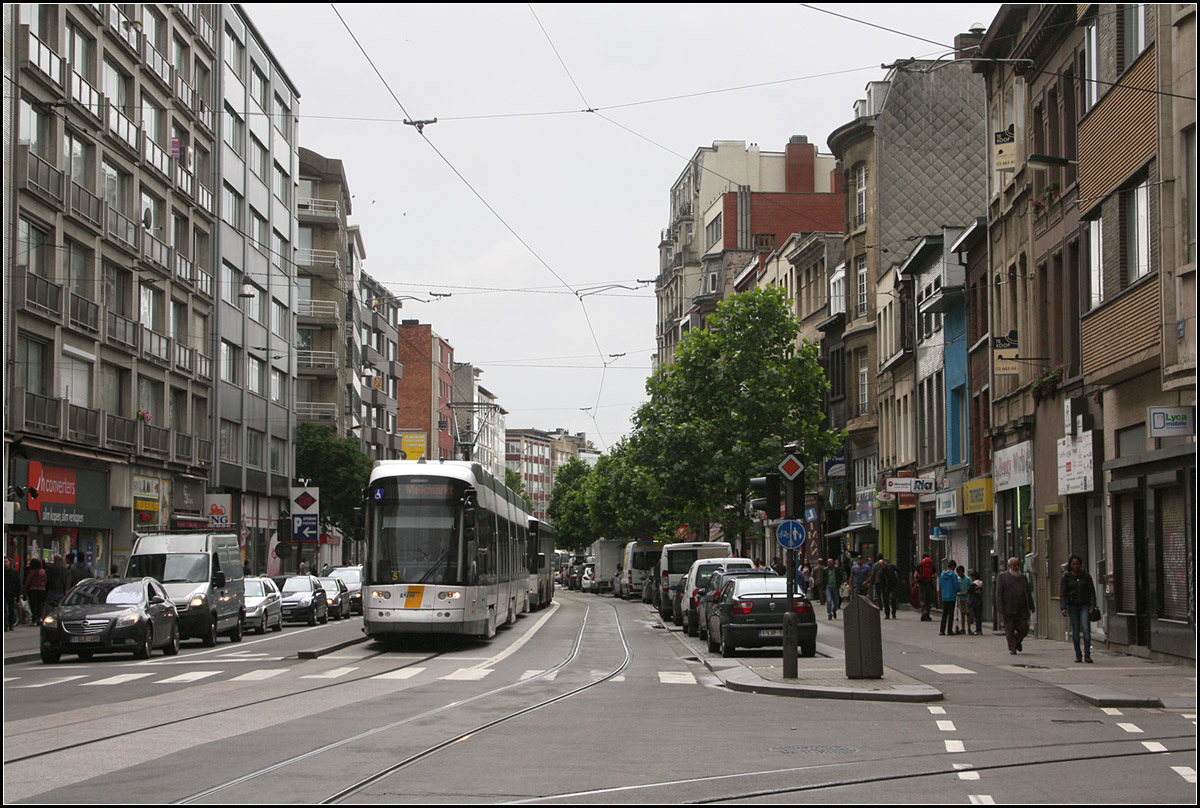 ... und unter der Straße gibt es auch einen Straßenbahntunnel -

Eine Flexity 2-Tram der Linie 10 in der Carnotstraat kurz vor der Station Centraal Station. Unter der Straße wurde ab 1977 die zweite Achse der Pre-Metro gebaut und dann nach Rohbaufertigstellung in 'Schlaf' versetzt. 2015 wurde dieser Tunnel 'aufgeweckt' und wird jetzt von der Linie 8 Astrid - Wommelgen befahren. Allerdings wurde neben der vorläufigen Endstation Astrid am Centraal Bahnhof nur die U-Station Zegel ausgebaut. Vier weiter U-Bahnhöfe dieser Strecke sind weiterhin nur im Rohbau vorhanden und werden durchfahren. 

Momentan wird die Strecke nach Westen weitergebaut mit der unterirdischen Station Opera (Kreuzung mit der ersten Pre-Metro-Achse) und eine Rampe zum Anschluss an die oberirdische Strecke in der Frankrijklei. Die Linie kann dann in Richtung Süden weiterfahren und wohl wird auch die Linie 10 die östlich der Station Zegel über einen kurzen Tunnelabzweig die Tunnelstrecke befahren. Sie kann dann aber nicht mehr in die Altstadt zum Melkmarkt fahren.

18.06.2016 (M)