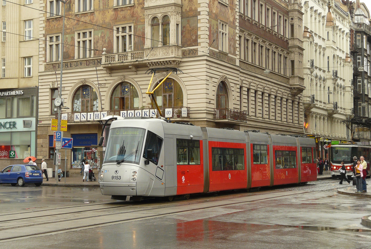 07. August 2010, Prag im Dauerregen. Die Straßenbahn kreuzt den Wenzelsplatz. Die Škoda 14 T sind (teilweise) niederflurige sechsachsige Multigelenkwagen in Einrichtungsbauart. Sie werden in Prag seit 2006 im Linienbetrieb eingesetzt. Hersteller ist Škoda Transportation Pilsen. Das Design entwarf Porsche Design. Die fünfteiligen Garnituren haben einen Gesamtlänge von 30 m, bieten Platz für 269 Fahrgäste und sind für eine Höchstgeschwindigkeit von 60 km/h zugelassen. Es befinden sich 60 Wagen mit den Nummern 9111 bis 9170 im Einsatz. (Quelle Wiki)