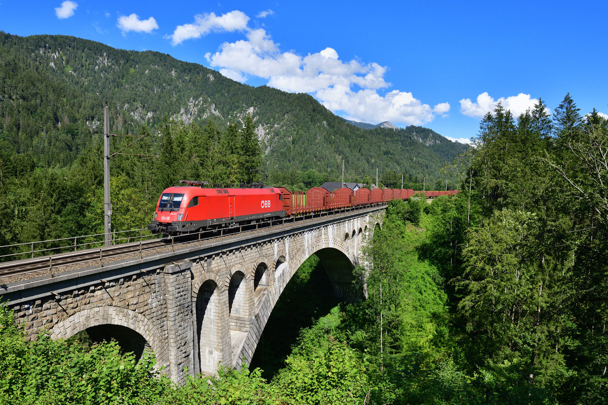 1016 013 mit einem Rungenwagenzug am 27.07.2020 bei St. Pankraz.