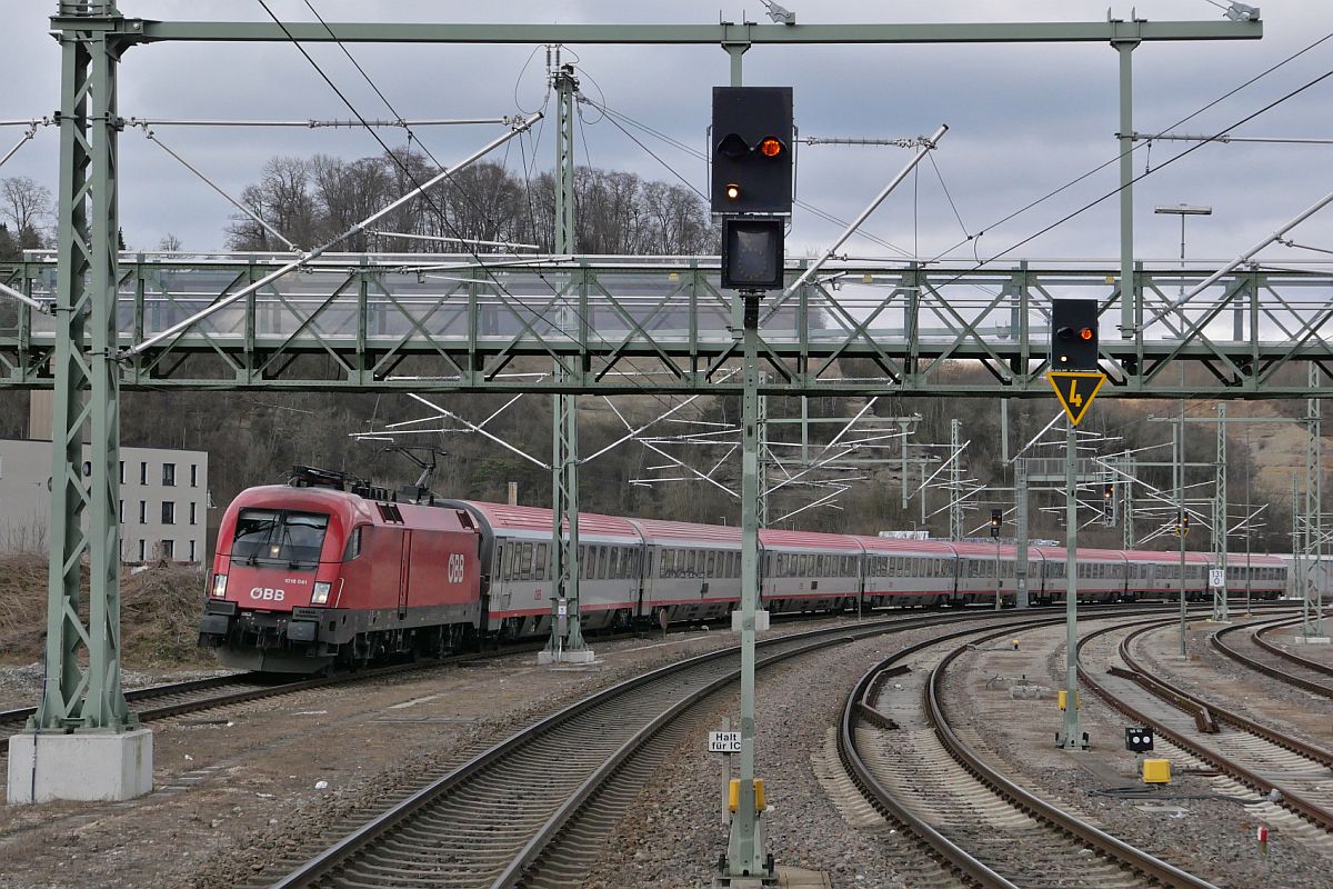 1016 041 mit den Wagen des IC 119  BODENSEE , Dortmund - Innsbruck, am 11.02.2022 bei der Einfahrt in den Bahnhof von Biberach (Riß). Aufnahmestandort das Ende des zwischen den Gleisen 2 und 3 liegenden Bahnsteigs.