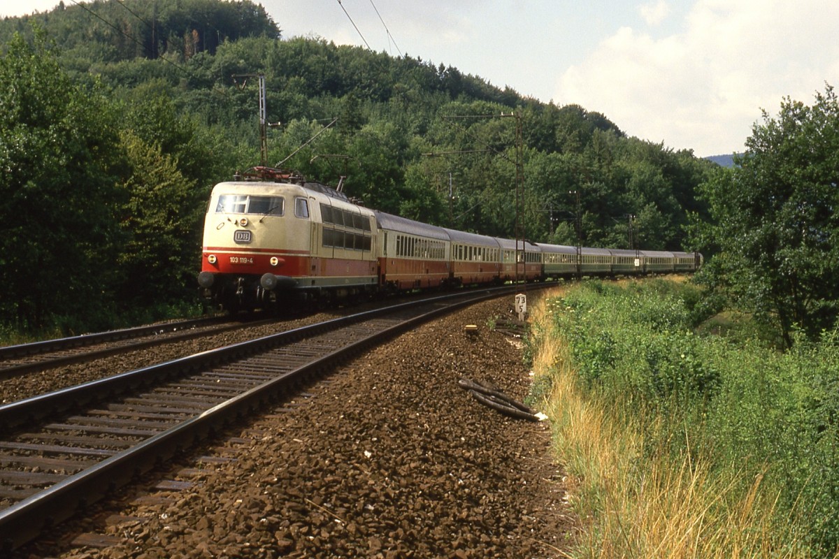 103 119 vor einem IC auf der Spessart-Rampe zwischen Laufach und Heigenbrücken im Sommer 1986.