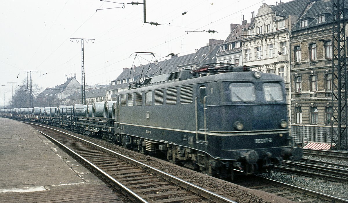 110 207 mit Stahlrollen  Köln. Da es schon immer selten war, dass eine E10 vor einem Zug mit Stahlrollentragwagen ingesetzt wurde, habe ich das Bild trotz Unschärfe hochgeladen.