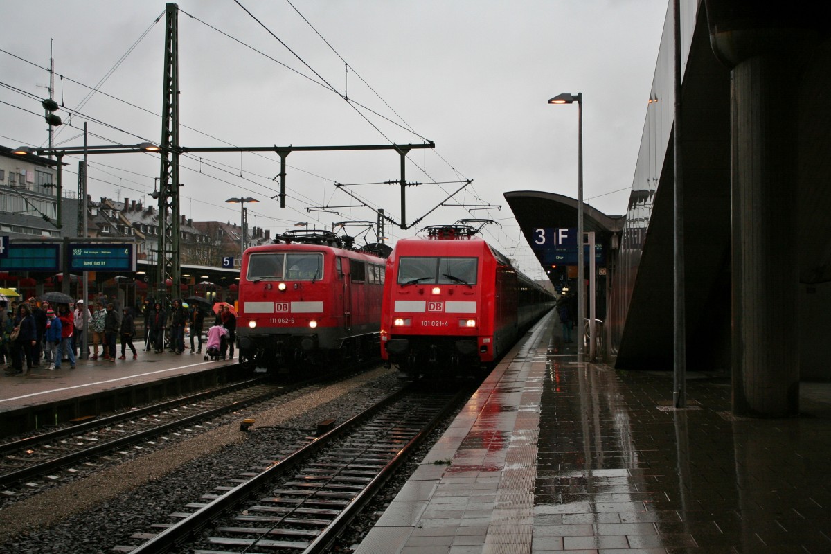 111 062-6 mit dem RE 5341 von Offenburg nach Basel Bad. Bf auf Gleis 4 und daneben 101 021-4 mit dem EC 9 von Hamburg Altona nach Chur HB am Nachmittag des 10.11.13 bei der Einfahrt in Freiburg (Breisgau) Hbf.