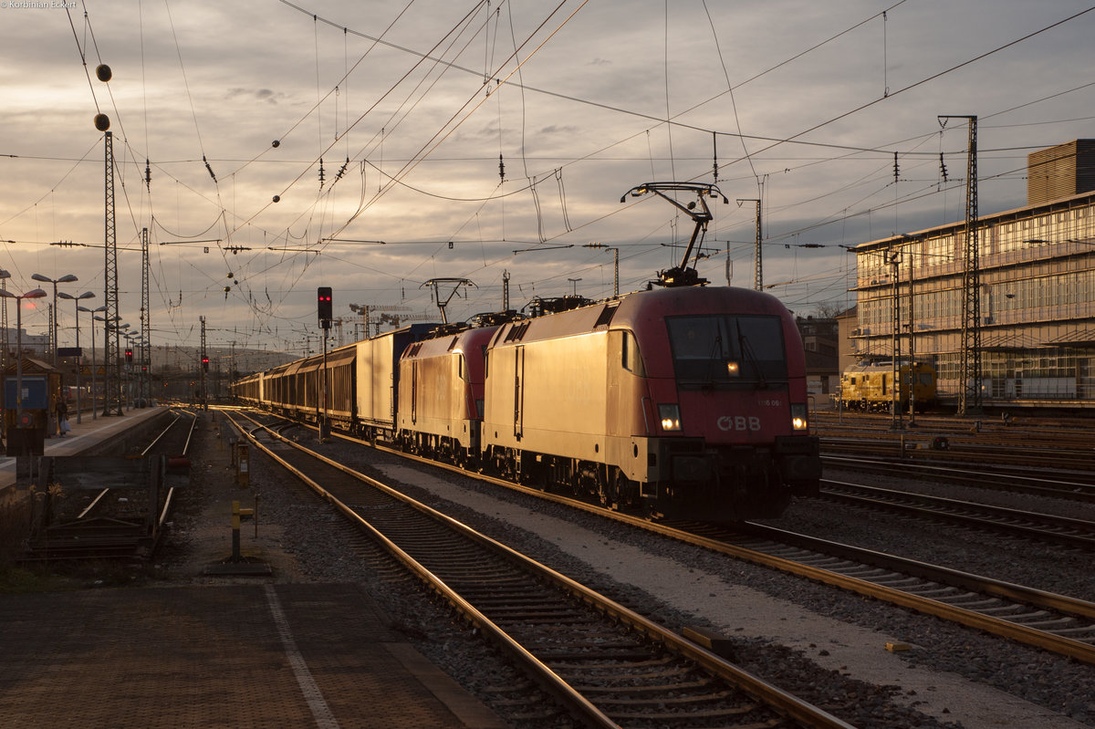 1116 061 mit einem weiteren Taurus und einem gemischten Güterzug im Abendlicht bei der Durchfahrt in Regensburg Hbf Richtung Passau, 04.03.2017