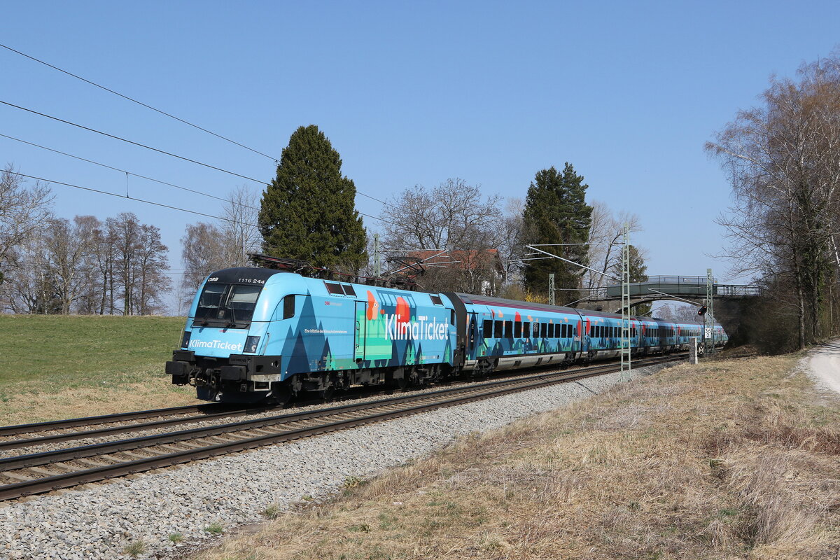 1116 244 mit dem  Klima-Railjet  aus Salzburg kommend am 28. März 2022 bei Übersee am Chiemsee.