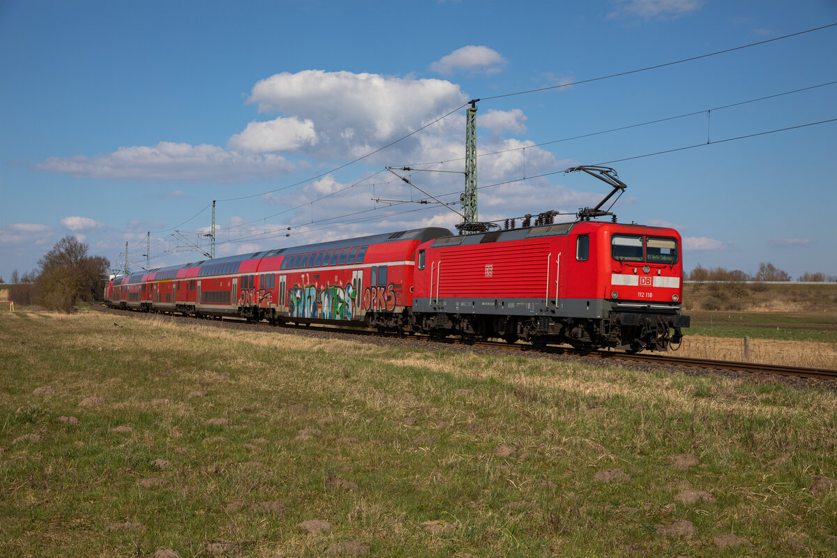 112 118 ziehend und 112 114 schiebend mit dem RE5 3515 von Stralsund, am 06.04.2023 in Wendorf.
