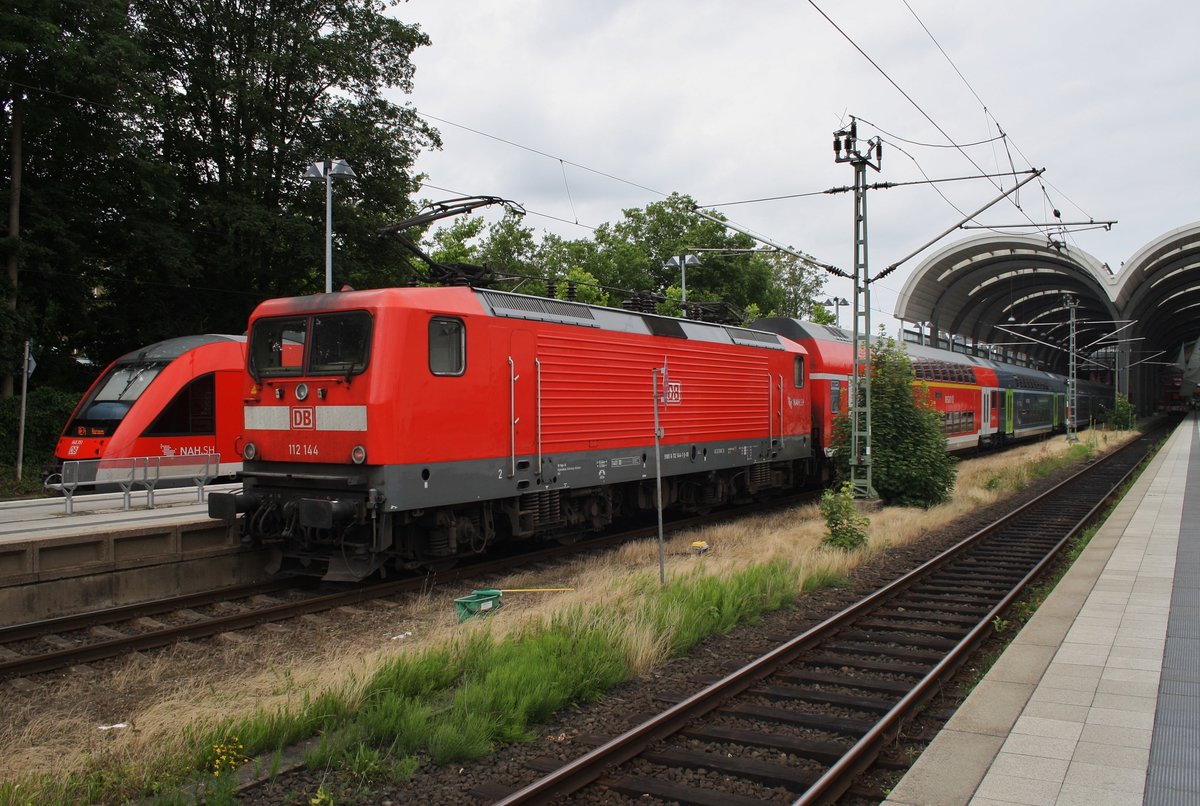 112 144 steht mit RE70 (RE21029) nach Hamburg Hauptbahnhof am Nachmittag des 11.7.2016 im Kieler Hauptbahnhof. Im Hintergrund wartet 648 351-4 als RE74 (RE21224) nach Husum. 