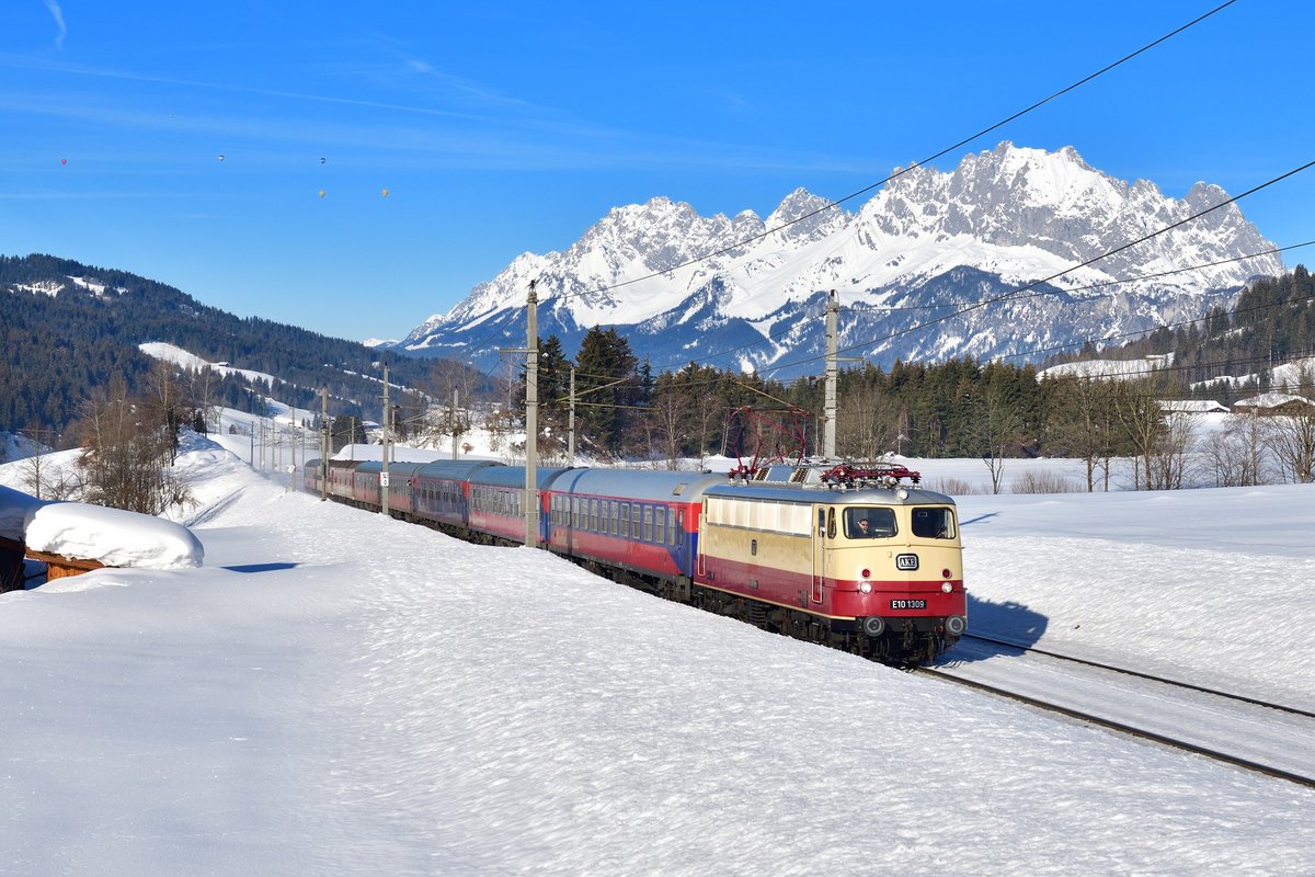 113 309 mit einem Turnuszug am 16.02.2019 bei Fieberbrunn.