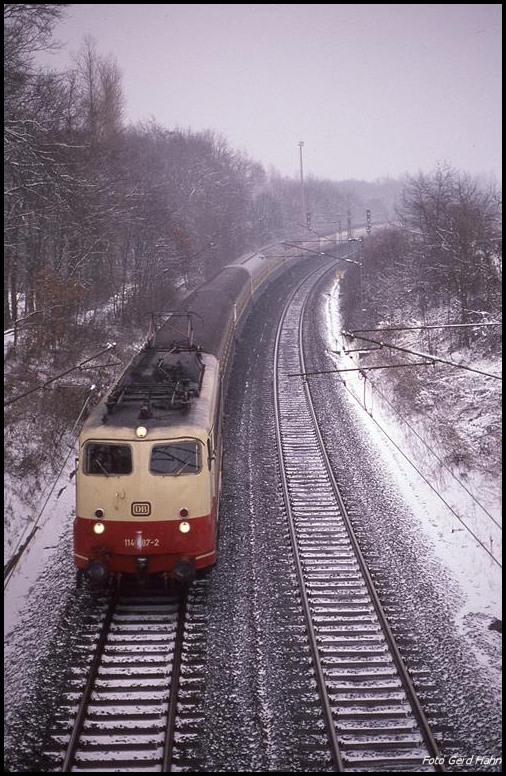 114487 ist hier am 13.2.1991 um 15.19 mit dem D 1034 nach Köln am Ortsrand von Hasbergen in Richtung Münster unterwegs.