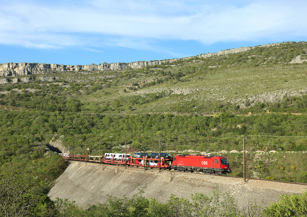 1216 142 approaches Hrastovljah whilst hauling a car train from the Port of Koper, 12 April 2016