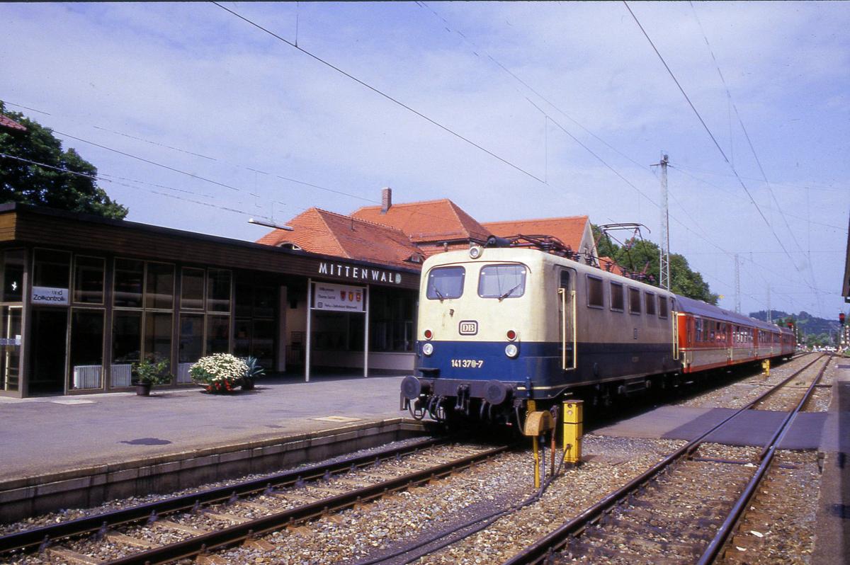 141370 am 12.9.1987 um 13.57 Uhr vor einer ÖBB Garnitur im Bahnhof Mittenwald.