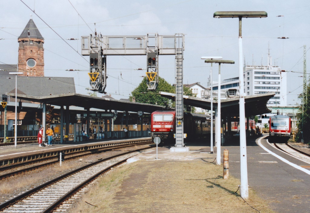 143 328 brachte am 30.8.05 eine Regionalbahn nach Gleis 14 in Gieen Hbf. Bemerkenswert ist die massive Signalbrcke vor dem Zug.