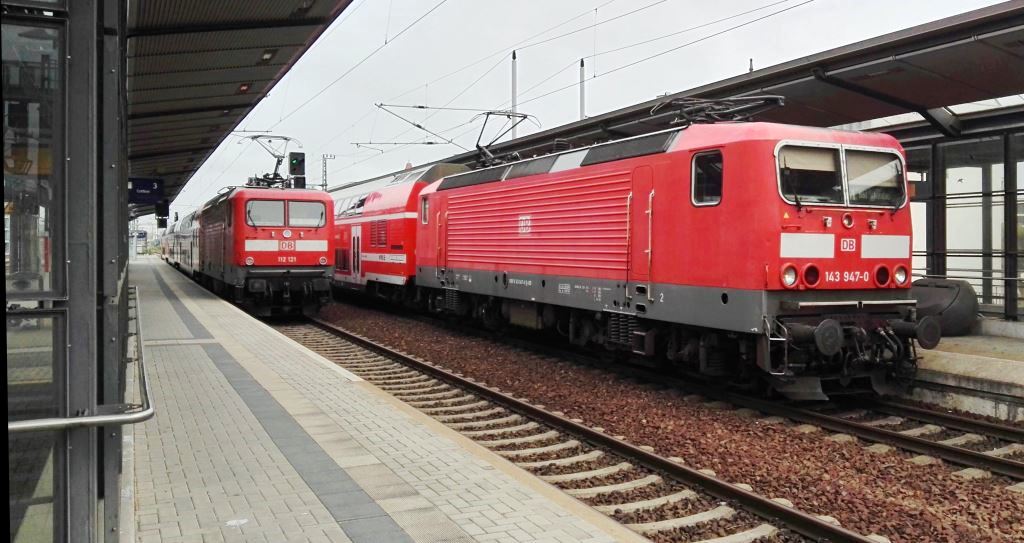 143 947-0 rechts auf Gleis 2 vor der S1 nach Bad Schandau. Auf Gleis 3 in der linken Bildseite ist 112 131 am Ende des RE nach Cottbus zu sehen. DD-Mitte am 17.08.2015.