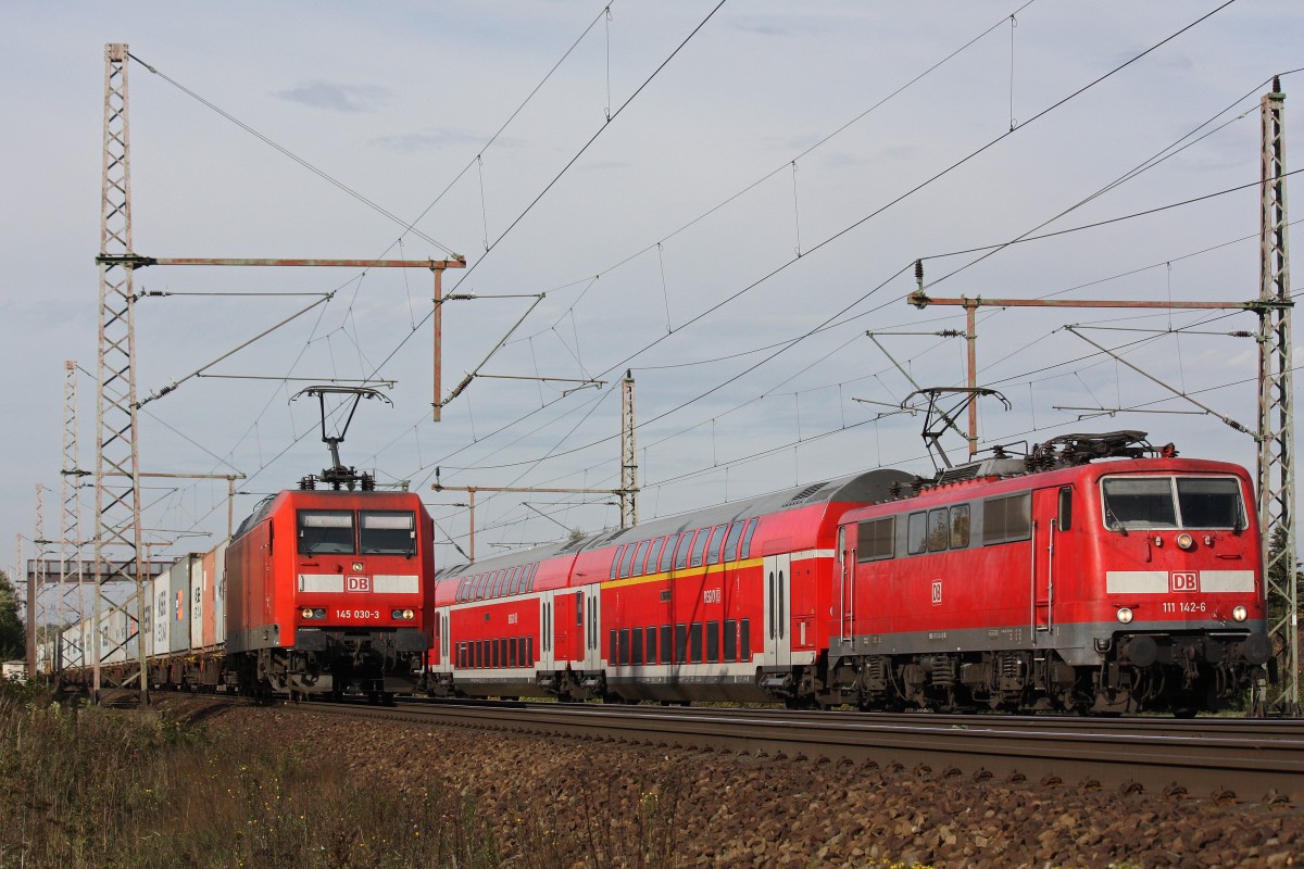 145 030 mit Containerzug und 111 142 mit RE am 19.10.13 in Dedensen-Gümmer.