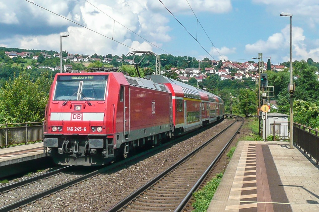 146 245 fuhr am 26.7.16 mit einem Doppelstock-RE nach Würzburg durch den neuen Haltepunkt Wernfeld. Er liegt etwa 500 Meter südlich vom alten Bahnhof und hat im Gegensatz zu diesem eine Unterführung.