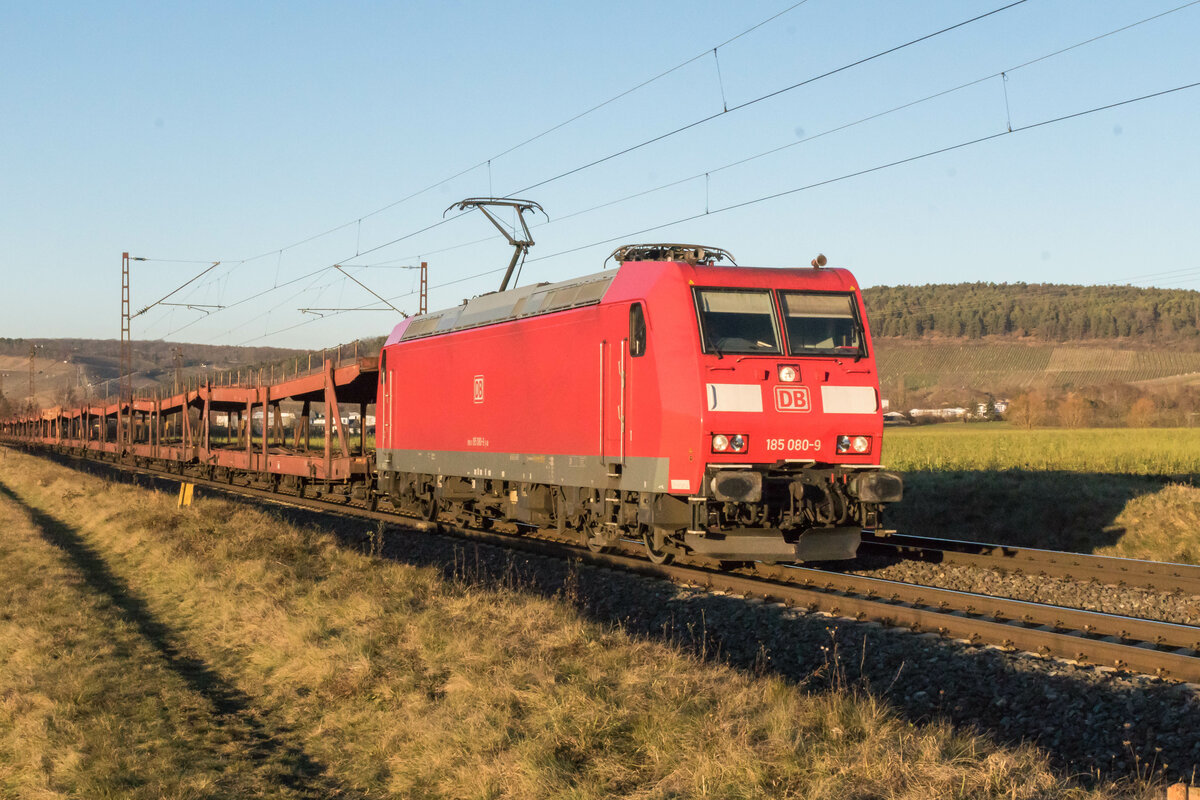 185 080-9 ist am 21.12.2021 mit einem leeren Autozug bei Retzbach unterwegs.