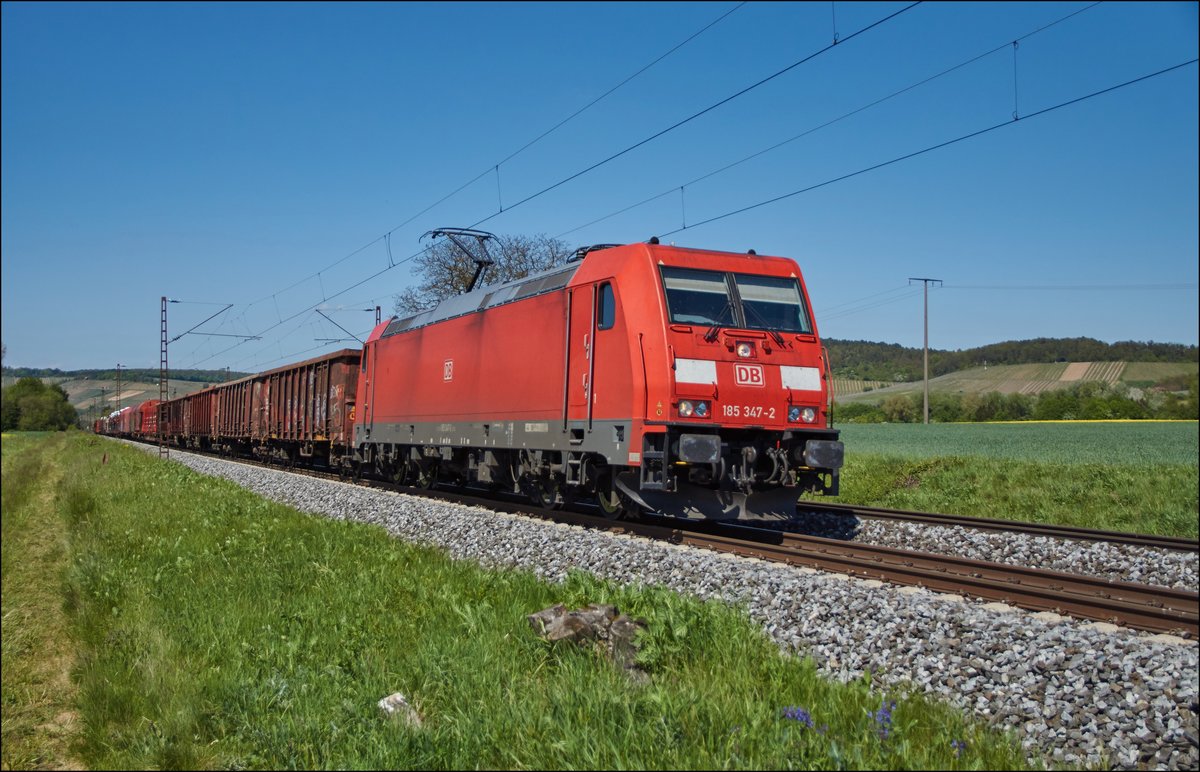 185 347-2 ist mit einen gemischten Güterzug in Richtung Würzburg am 10.05.2017 bei Retzbach-Zellingen unterwegs.