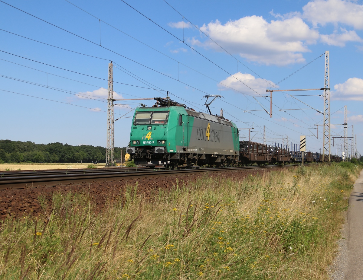 185 533-7 mit Stahl auf Rungenwagen in Fahrtrichtung Wunstorf. Aufgenommen am 23.07.2014 bei Dedensen-Gümmer.