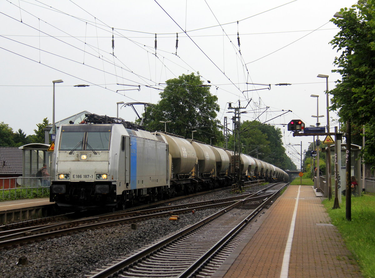 186 187-1 von Railpool kommt mit einem langen Silozug durch Kohlscheid aus Buna-Werke(D) nach Herentals(B) und fährt die Kohlscheider-Rampe hoch nach Aachen-West.
Aufgenommen vom Bahnsteig 1 in Kohlscheid.
Bei Regenwetter am Nachmittag vom 14.6.2018. 