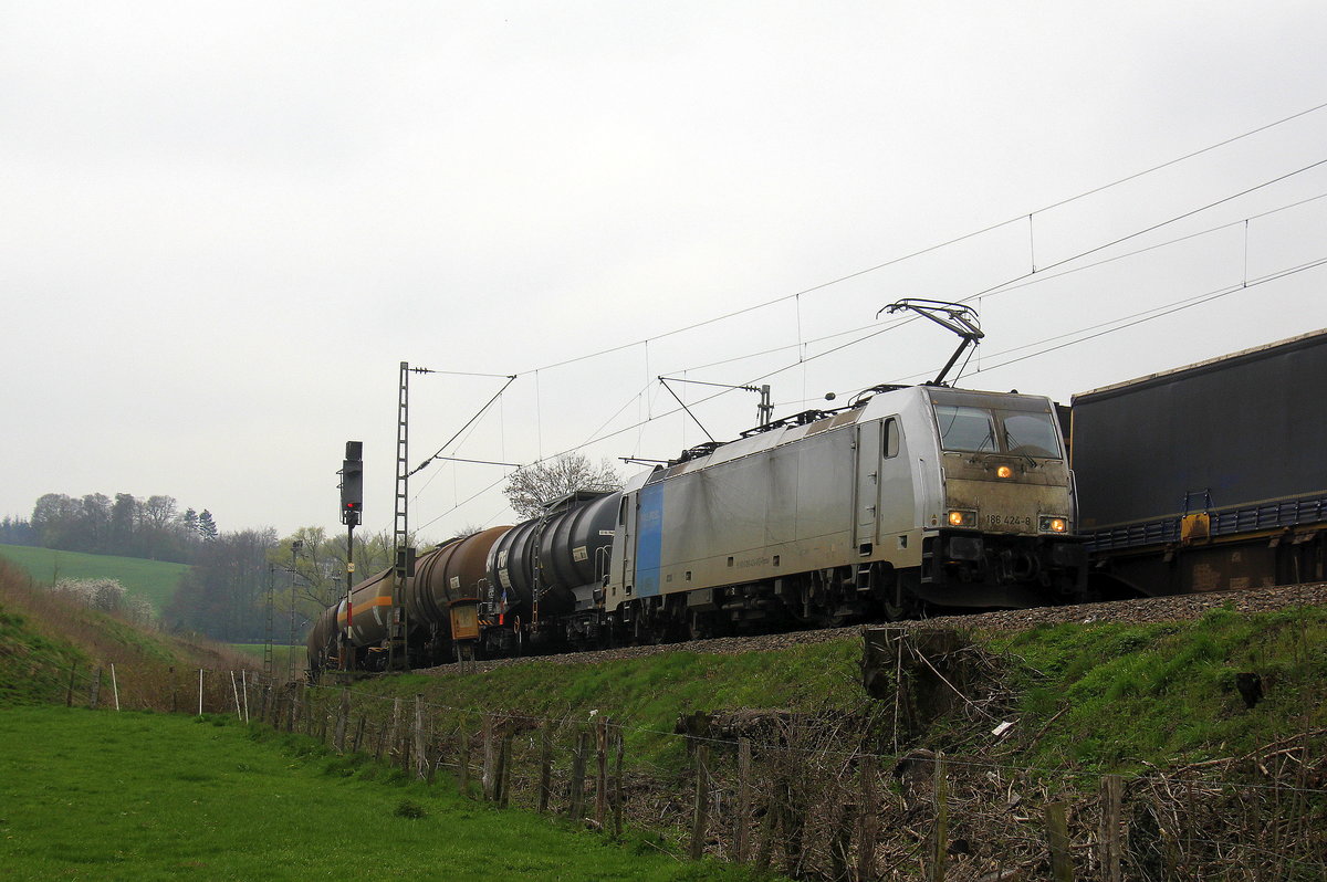 186 424-8 von Lineas/Railpool kommt die Gemmenicher-Rampe herunter nach Aachen-West mit einem  gemischten Güterzug aus Antwerpen-Noord(B) nach Köln-Gremberg(D).
Aufgenommen von einem Weg in Reinartzkehl. 
Bei Wolken am Kalten Nachmittag vom 5.4.2019.