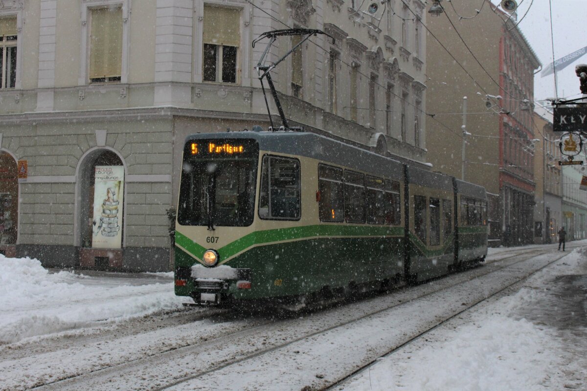 1986 wurden von der SGP in Graz zwölf Stück der 600er Wagen an die Grazer Verkehrsbetriebe geliefert. 
Wegen des zu geringen Platzangebotes wurden 1999 von Bombardier zwölf niederflurige Zweischenteile geliefert.
Im dichten Schneefall des 9.12.2021 fährt der Wagen 607 auf der Linie 7 kurz vor der Haltestelle Schlossbergplatz/Murinsel in Richtung Puntigam.