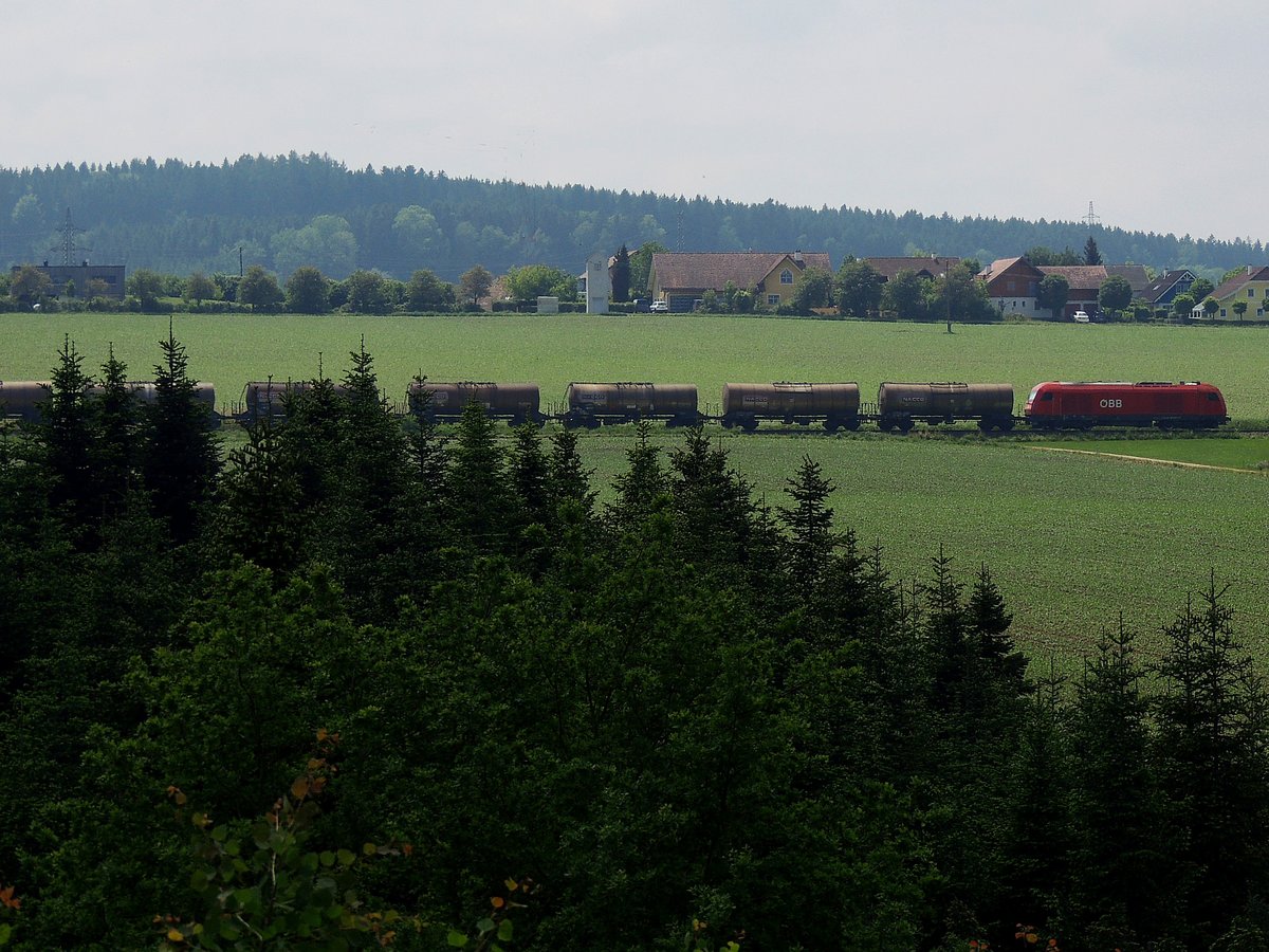 2016 066-9 streift mit Kesselwagenleerzug (GAG47850) durch die Ausläufer des Hausruckwaldes seinem nächsten Zwischenstopp Ried entgegen; 180511