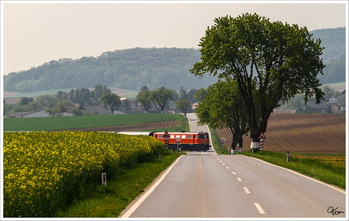 2050.09 überquert mit dem Erlebniszug  Leiser Berge  die Eisenbahnkreuzung nahe  Naglern. 1_5_2014