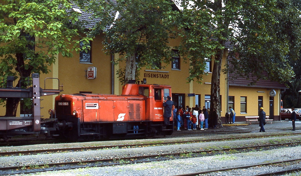 2062 055-5 rangiert im Juni 1987 im idyllischen Bahnhof Eisenstadt. Ein Ortsunkundiger würde kaum vermuten, dass es sich hierbei um den Bahnhof einer österreichischen Landeshauptstadt (Burgenland) handelt. Den Aufkleber, der auf das in diesem Jahr begangene 150-jährige Jubiläum der österreichischen Eisenbahnen hinweist, trugen damals alle ÖBB-Triebfahrzeuge.