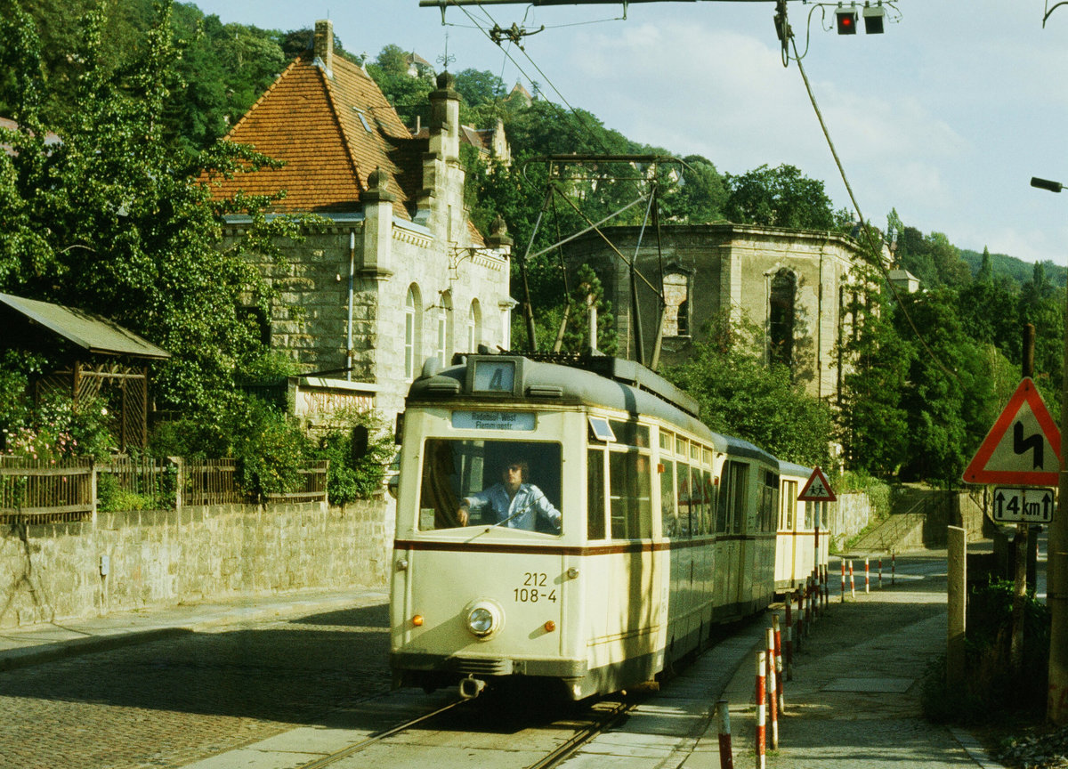 21.10.1984: Straßenbahnzug der Linie 4 auf der Pillnitzer Landstraße in Dresden-Loschwitz. Tw 212 108 stammt aus einer Serie (101 bis 116) die 1954 in Werdau gebaut worden ist. Im Hintergrund ist die Ruine der von George Bär erbauten Loschwitzer Kirche zu sehen. Sie wurde mittlerweile wieder aufgebaut. Im linken Sandsteingebäude befindet sich die Talstation der Schwebeseilbahn.