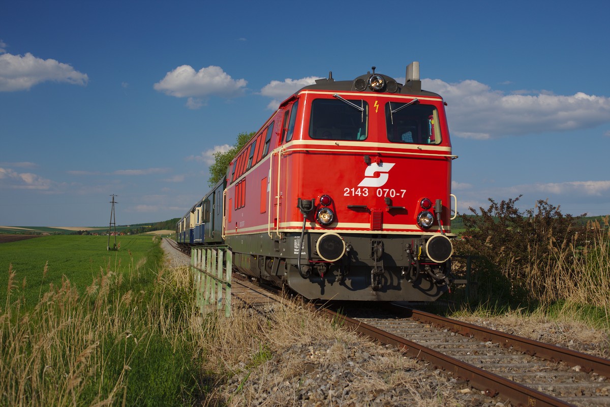2143.070 mit ihrem Zug kurz vor Rückersdorf-Harmannsdorf. (07.05.2016)