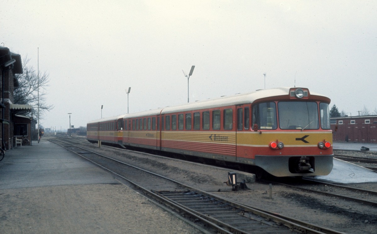 ØSJS (Østbanen): Bahnhof Hårlev am 23. Dezember 1975. - Ein doppelter Triebzug (Ys+Ym+Ys+Ym) ist gerade in Hårlev von Køge angekommen. Nach einigen Minuten wird die vordere Wagengarnitur weiter nach Fakse Ladeplads fahren, während die hintere Rødvig als Zielbahnhof hat. - Die beiden Garnituren waren 1974 von der Waggonfabrik Uerdingen AG gebaut und geliefert worden. 