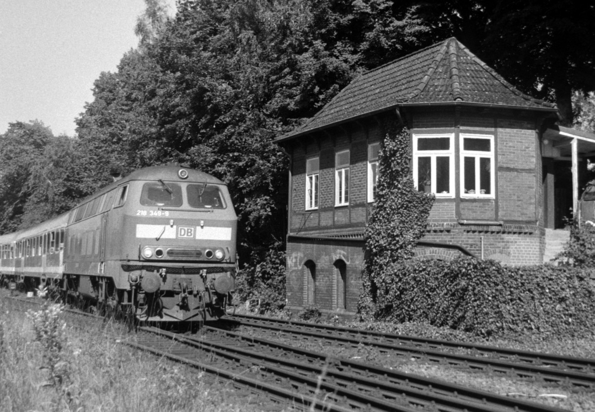 218 349 mit RE 35208 (Hamburg–Lbeck–Kiel) am 15.07.2002 neben dem alten Stellwerk  Plf  (Auerbetriebnahme 1988) in Pln