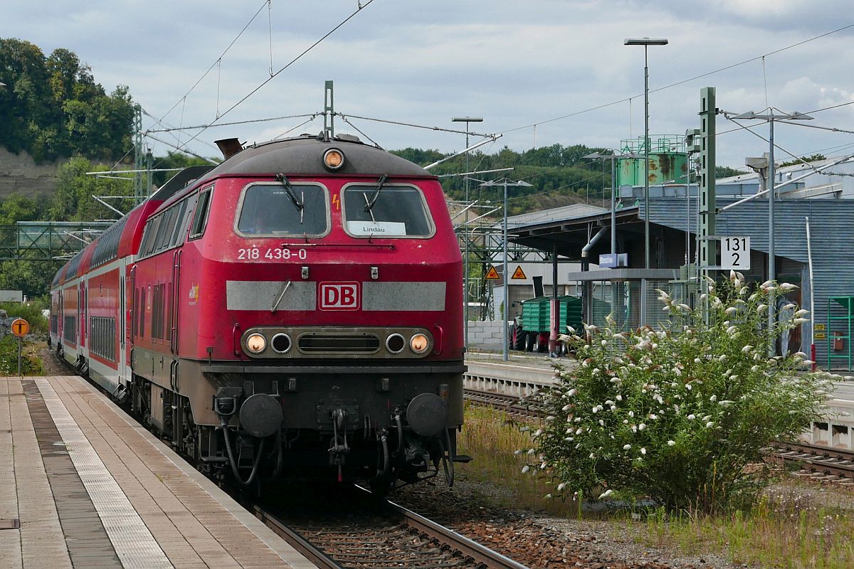 218 438-0 mit den Wagen des RE 4241 von Stuttgart nach Lindau am 24.07.2020 bei der Einfahrt in den Bahnhof von Biberach (Riß). Drei Tage nach der Aufnahme war der blühende Busch nicht mehr da und es klaffte an jener Stelle ein Loch.