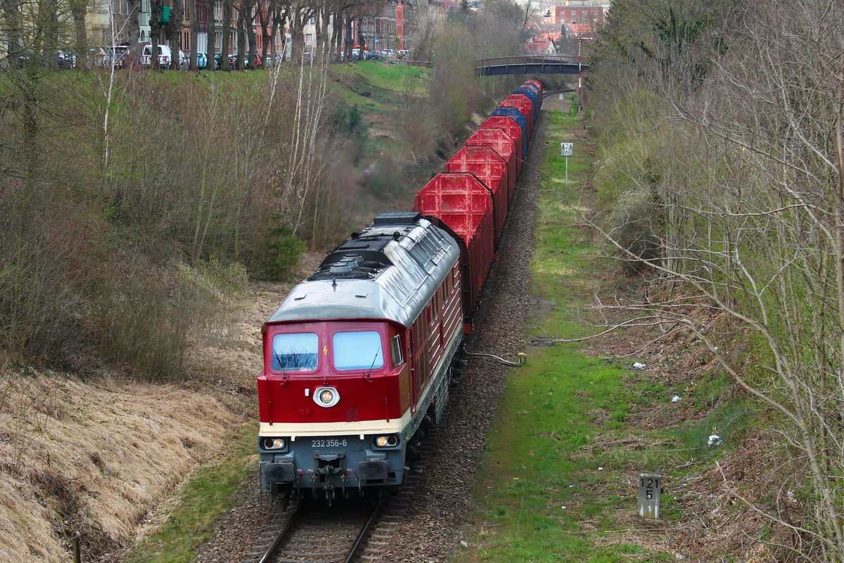 232 356-6 (WFL) mit einem leeren Holzzug am 15.4.2021 auf dem Weg nach Triptis. Hier zu sehen bei der Durchfahrt durch Pößneck. 