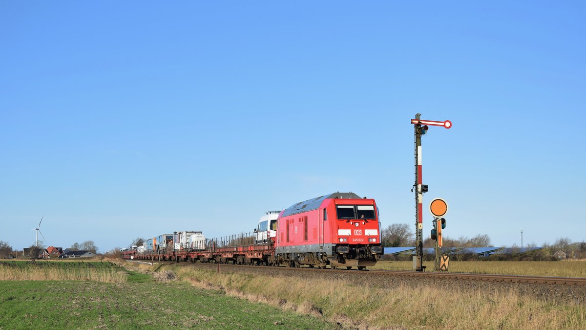 245 022 zieht einen Autozug nach Niebüll aus dem Ort Klanxbüll hinaus. Hier passiert der Zug gerade das Einfahrsignal der Gegenrichtung. Aufgenommen am 9.1.2019 12:38