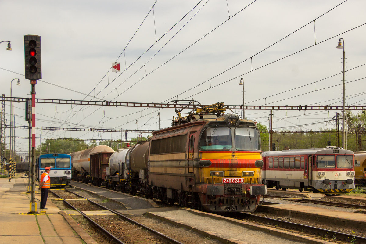 26. April 2019 in Kuty. 240 024-0 durchfährt mit einem Mischer unter den strengen Augen des Fdl den Bahnhof gen Süden. 