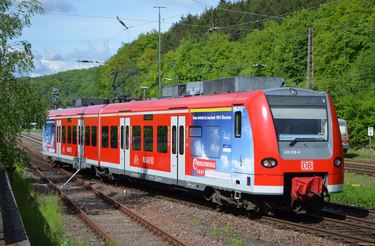 426 038 zeigte sich bei der Ausfahrt aus Türkismühle als RB 73 nach Saarbrücken am 30. Mai 2013 in der besten Mittagssonne. 

Werbeloks der Baureihe 101 oder auch einiger anderer Baureihen sind ja recht bekannt. Eine Besonderheit waren aber Werbetriebwagen der Baureihe 426 im Elektronetz Saar(land). 426 038 trug insgesamt drei verschiedene Werbebeklebungen für die Energiewende im Saarland, ehe das E-Netz Saar im Jahre 2019 an die vlexx überging. 
