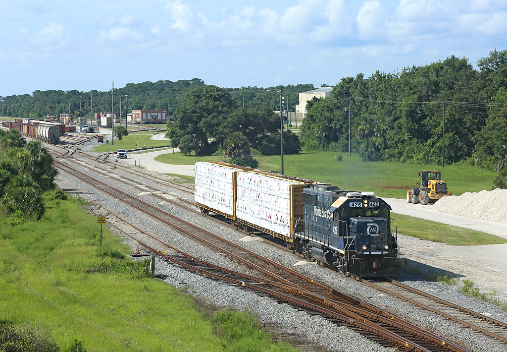 426 departs the yard at New Smyrna Beach with two cars for Daytona, 5 July 2018.

This is FEC local 910 which works industries in the NSB area...