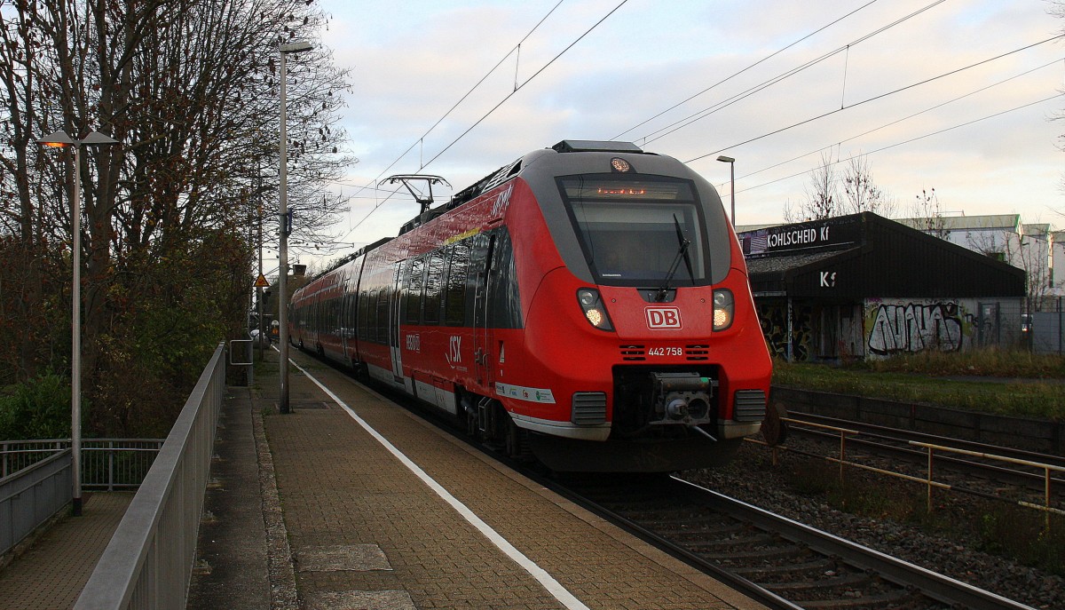 442 758 DB  kommt aus Köln nach Aachen-Hbf und fährt durch Kohlscheid aus Richtung Herzogenrath und fährt die Kohlscheider-Rampe hoch nach Aachen-West. 
Bei Sonne und Regenwolken am Morgen vom 16.11.2015.