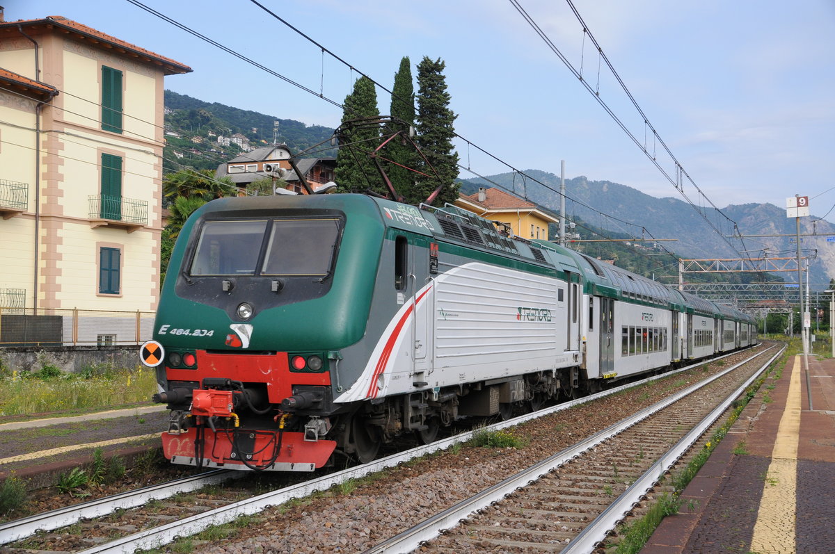 464 204 schiebt ihren Regioanlzug Milano Centrale nach Domodossola am 25.06.2020 um 09:53 Uhr pünktlich aus dem Bahnhof Stesa. 