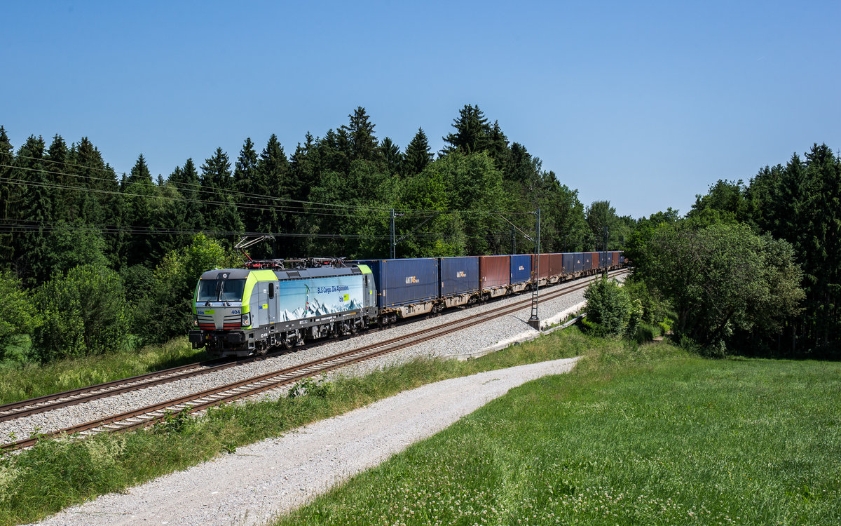 475 404 der BLS, welche momentan im Einsatz für Lokomotion ist, fährt mit einem Containerzug bei Grabenstätt in Richtung München, aufgenommen am 13. Juni 2017.