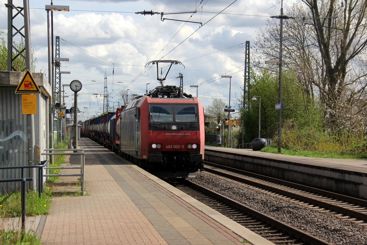 482 002-3 von SBB-Cargo  kommt als Umleiter mit einem Containerzug aus Gallarate(I) nach Antwerpen-Oorderen(B) und kommt aus Richtung Köln-Süd,Köln-West,Köln-Nippes,Köln-Longerich,Köln-Chorweiler,Köln-Worringen,Dormagen-Bayerwerk,Dormagen und fährt durch Nievenheim in Richtung Neuss-Allerheiligen,Norf,Neuss-Süd,Neuss-Hbf,Meerbusch-Osterath,Krefeld-Oppum,,Krefeld-Hbf,Forsthaus,Anrath,Viersen,Mönchengladbach,Rheydt-Gbf,Wickrath,Herrath,Erkelenz,Hückelhoven-Baal,Brachelen,Lindern,Süggerath,Geilenkirchen,Frelenberg,Zweibrüggen,Übach-Palenberg,Rimburg,Finkenrath,Hofstadt,Herzogenrath, Kohlscheid,Richterich,Laurensberg,Aachen-West. 
Aufgenommen vom Bahnsteig 1 in Nievenheim. 
Bei Sonne und Wolken am Nachmittag vom 15.4.2018.