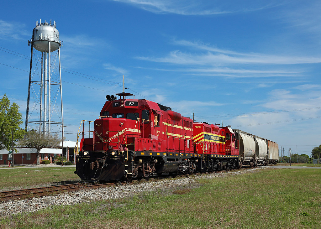 57 & 55 pass Eagle Lake whilst taking three cars from Winter Haven to the Bartow Airport industrial complex, 1 March 2019