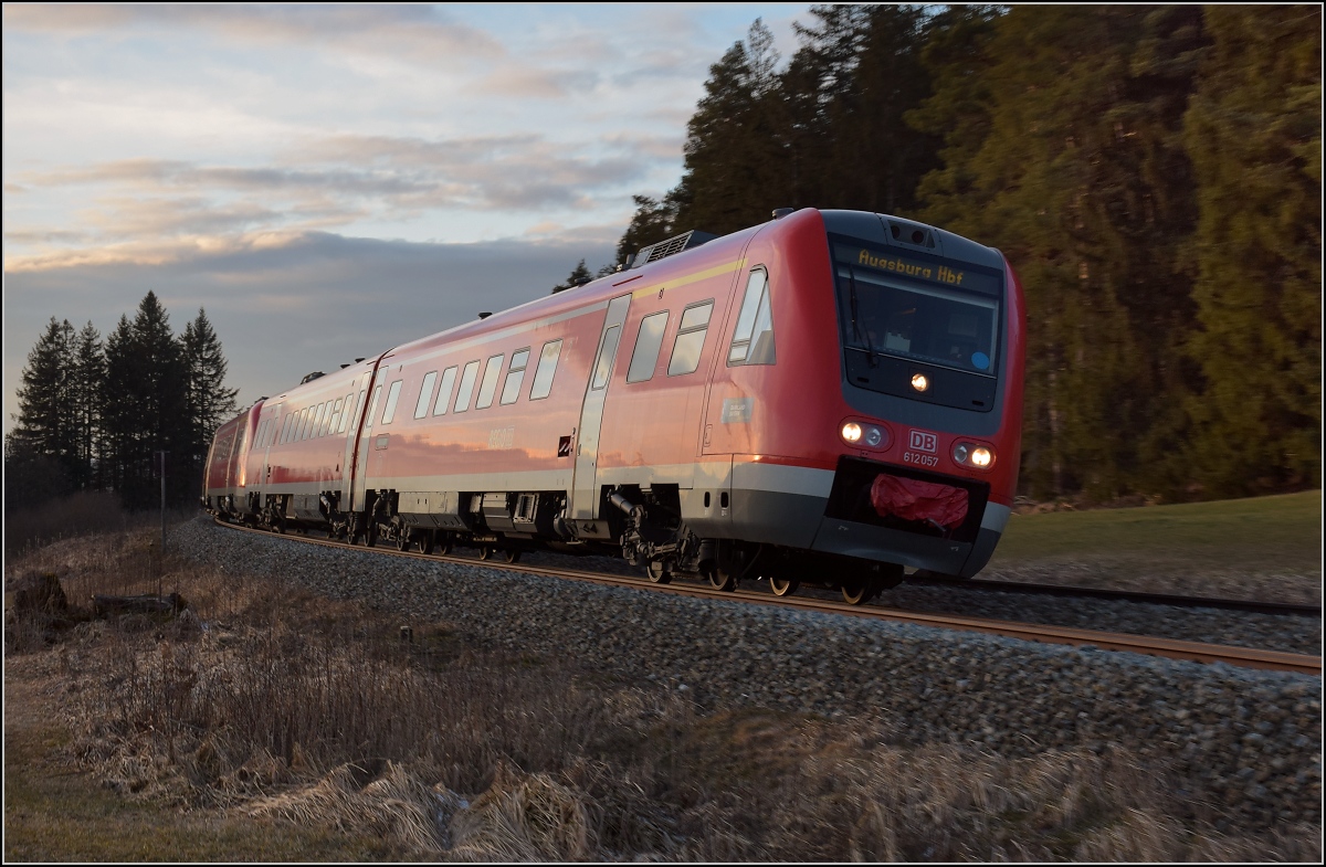 612 057 und 612 059 neigen sich beim Kraftwerk Ruderatshofen unter den letzten Sonnenstrahlen des Tages in die Kurve. Februar 2018.