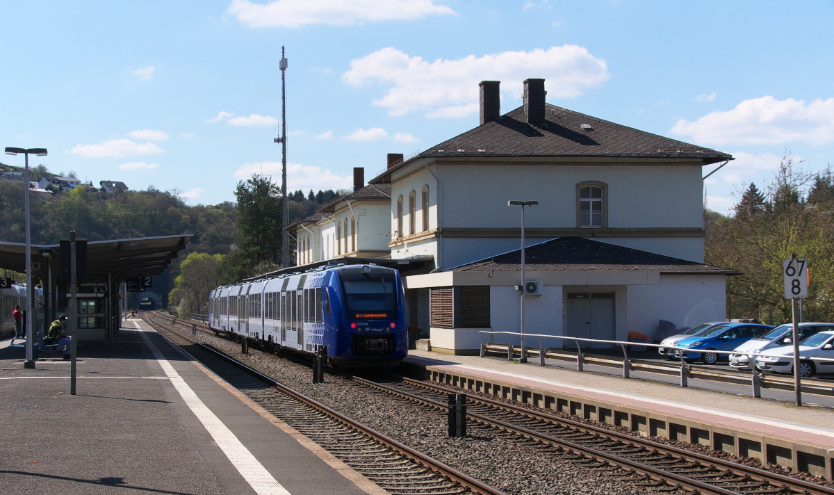 620 404 der VLEXX hat Planhalt in Idar-Oberstein. Trotz Gegenlicht mußte diese Aufnahme auf den Chip. Die Strecke 3511 Bingerbrück - Saarbrücken hat zwischen Neunkirchen/Saar und Bad Kreuznach jeglichen Güterverkehr verloren, ausgenommen die wenigen Militärzüge nach Baumholder. Zwischen Neubrücke/Nahe und Bad Kreuznach ist der Personenverkehr in der Hand des VLEXX. Die anfänglichen Schwierigkeiten scheinen langsam überwunden zu sein, jedenfalls fahren die VLEXX `e auf der Rhein-Nahebahn pünktlich. 18.04.2015